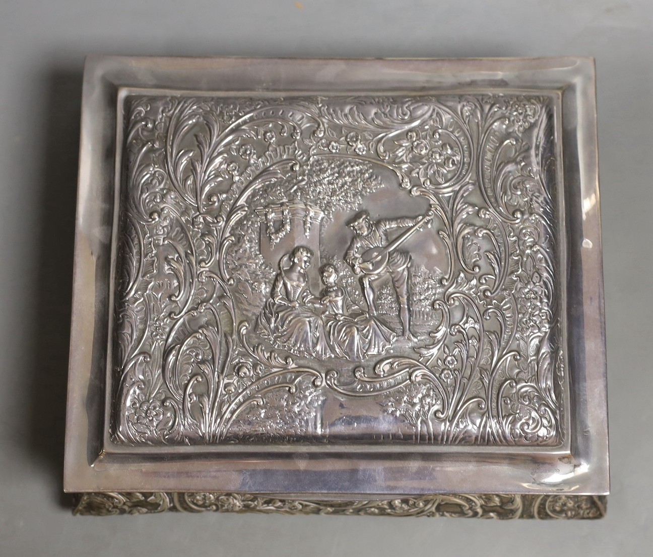 An Edwardian embossed silver mounted rectangular bombe shaped jewellery casket, Henry Matthews, Birmingham, 1905, 19.2cm.